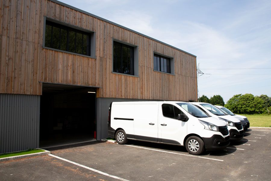 Business Auto Insurance - Fleet of Vans Outside of a Loading Dock