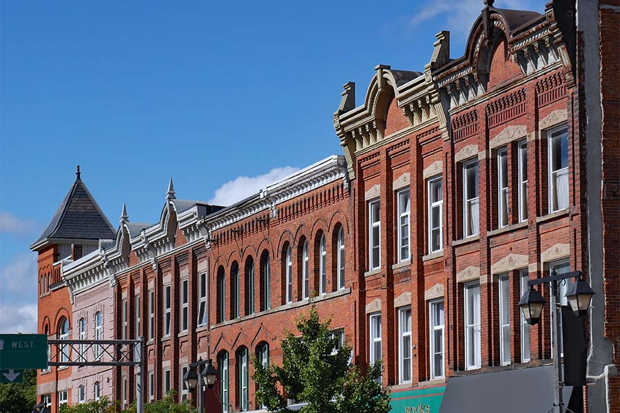 London, KY - Row of Red Brick Commercial Buildings Along a Main Street in Downtown London Kentucky Against a Blue Sky